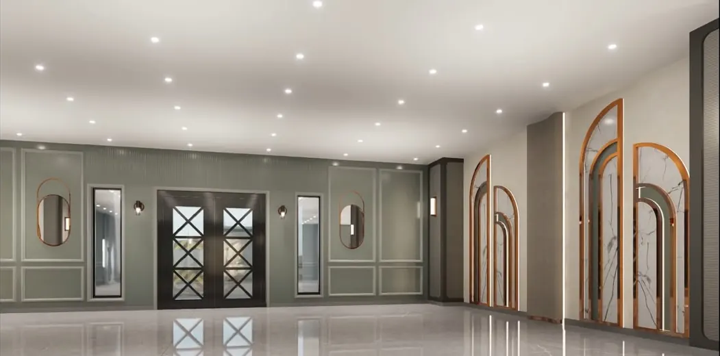 Interior of Shams Convention — arched bronze-framed marble panels along a sage-green wall above a polished reflective floor